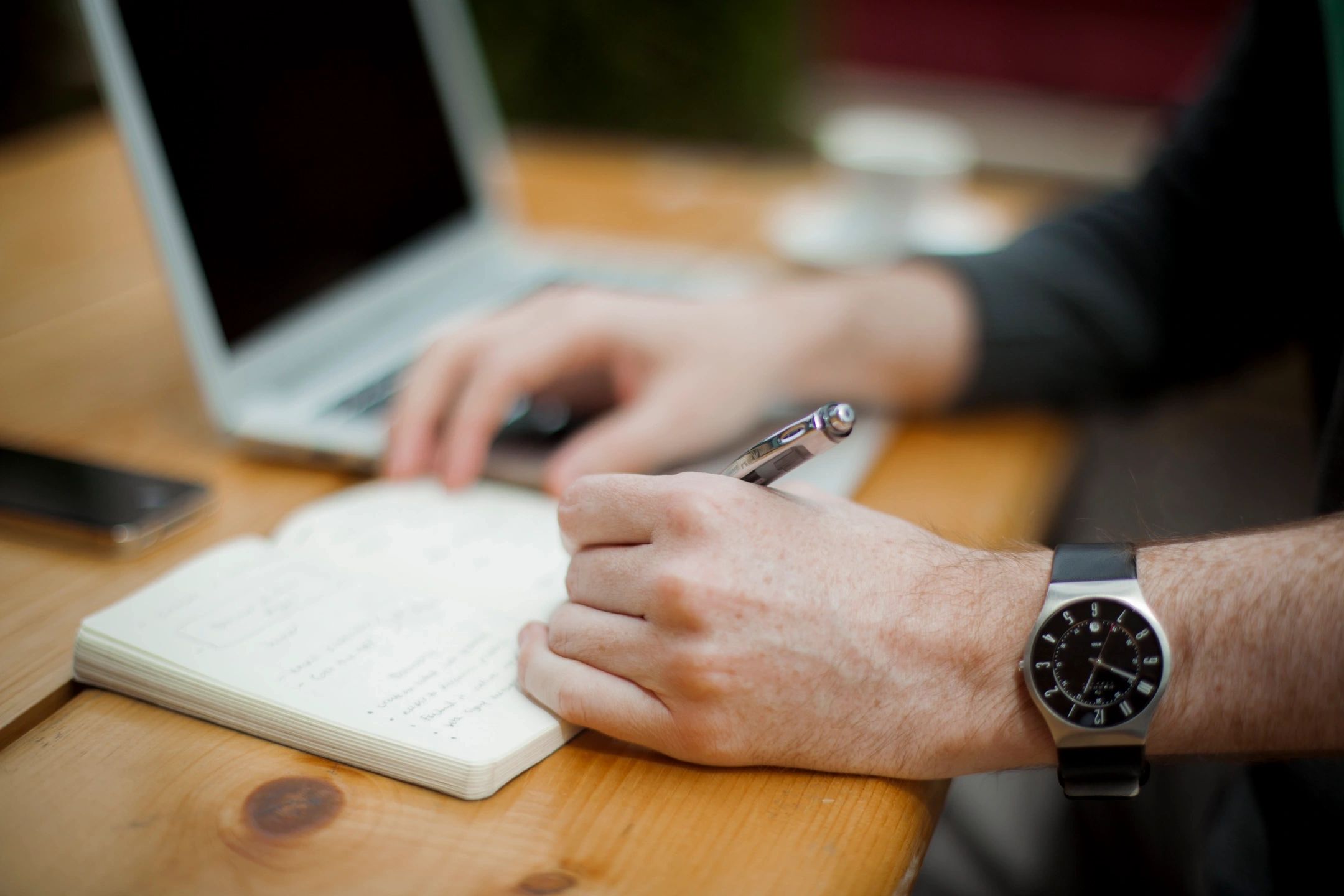 person writing in a notebook